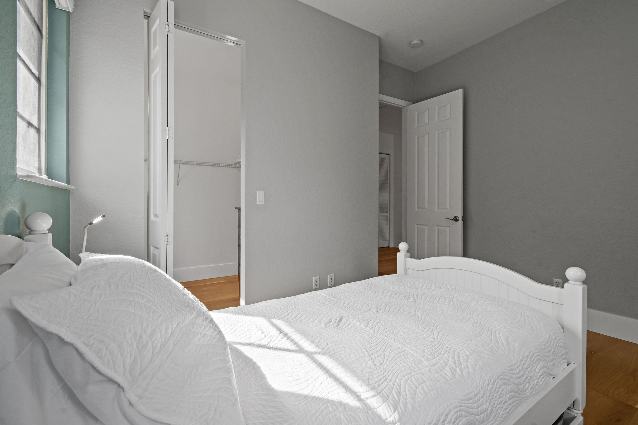 158 Ennis Lane Jupiter, FL 33458 - Photo 52 of 77 a bedroom with a bed and a lamp