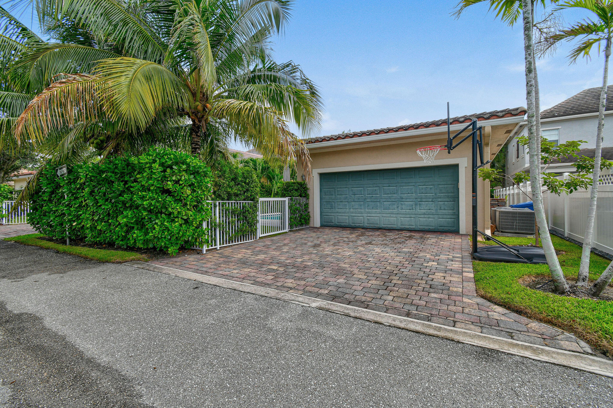 158 Ennis Lane Jupiter, FL 33458 - Photo 72 of 77 a front view of a house with a yard and garage