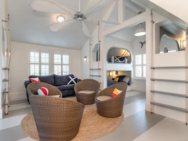 a living room with furniture flowerpot and window