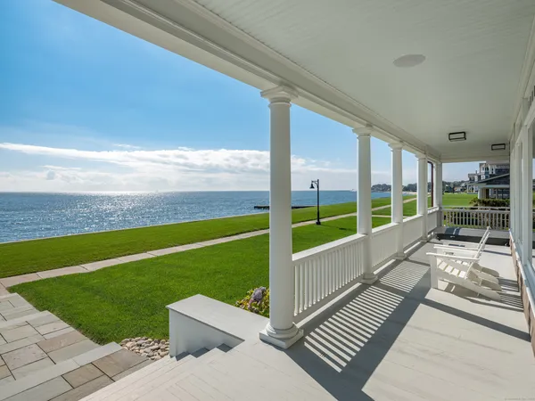 a view of a balcony with floor to ceiling windows with wooden floor