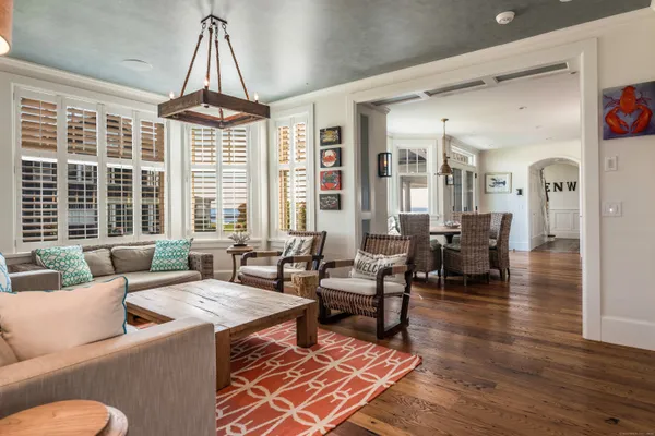 a living room with furniture and floor to ceiling windows