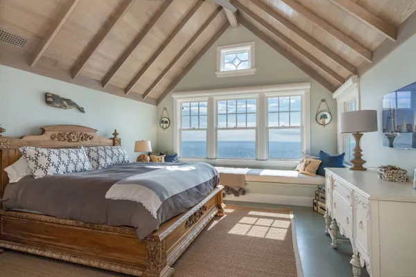 a bedroom with a large bed and a couch