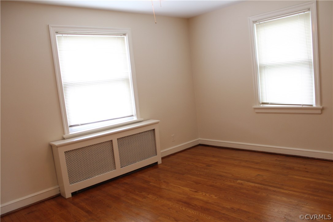 2426 Kenmore Road Henrico, VA 23228 - Photo 8 of 27 an empty room with wooden floor and a window