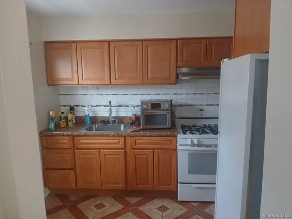 a kitchen with stainless steel appliances a refrigerator and a stove top oven