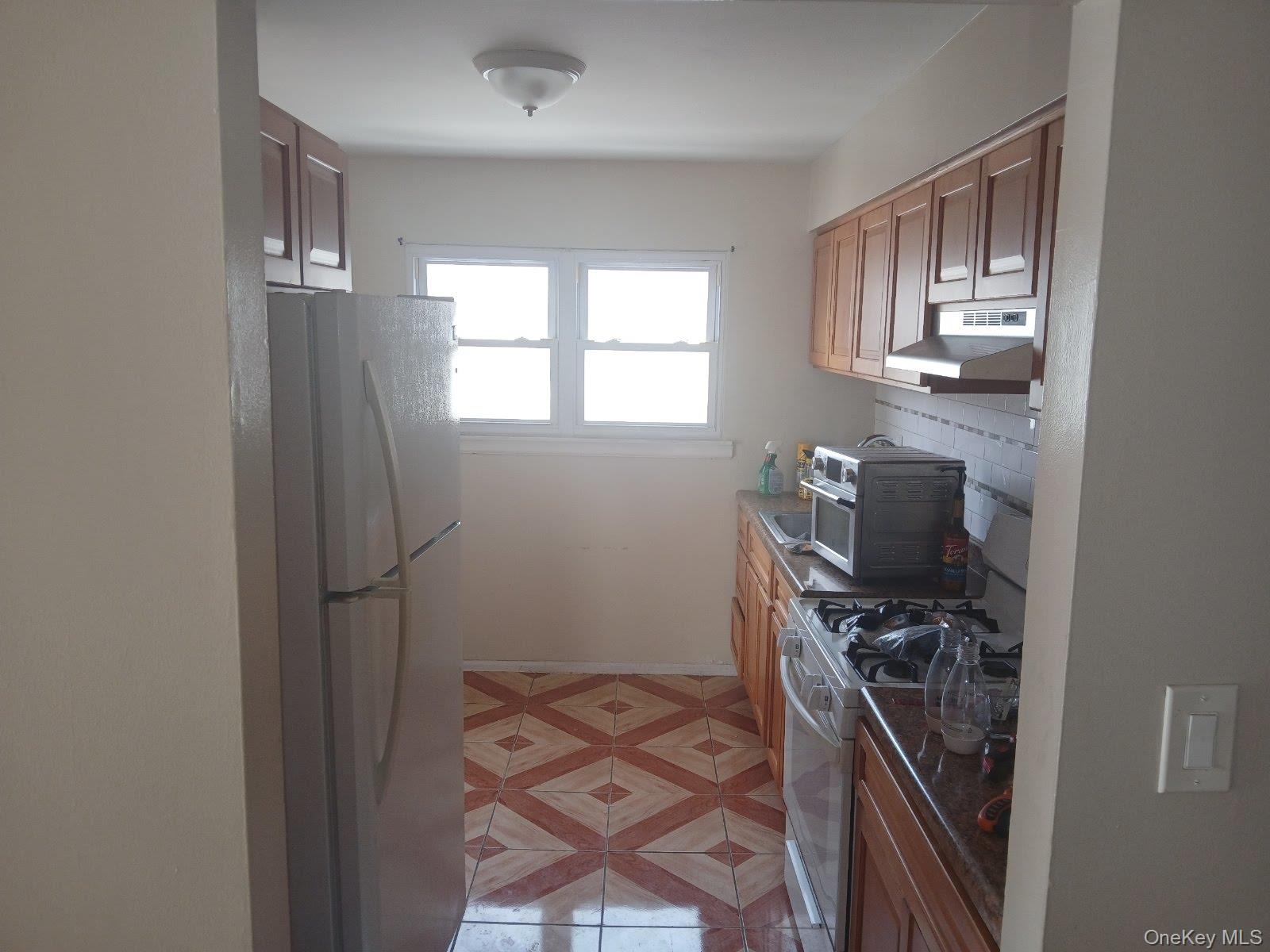 255-29 149th Road Queens, NY 11422 - Photo 14 of 23 a kitchen with stainless steel appliances a refrigerator and a stove top oven