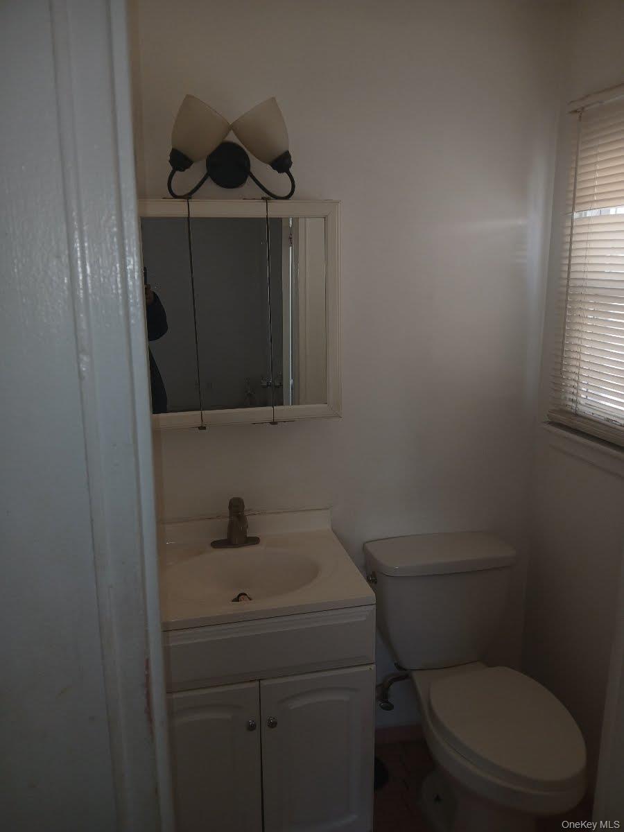 255-29 149th Road Queens, NY 11422 - Photo 20 of 23 a bathroom with a toilet sink and mirror