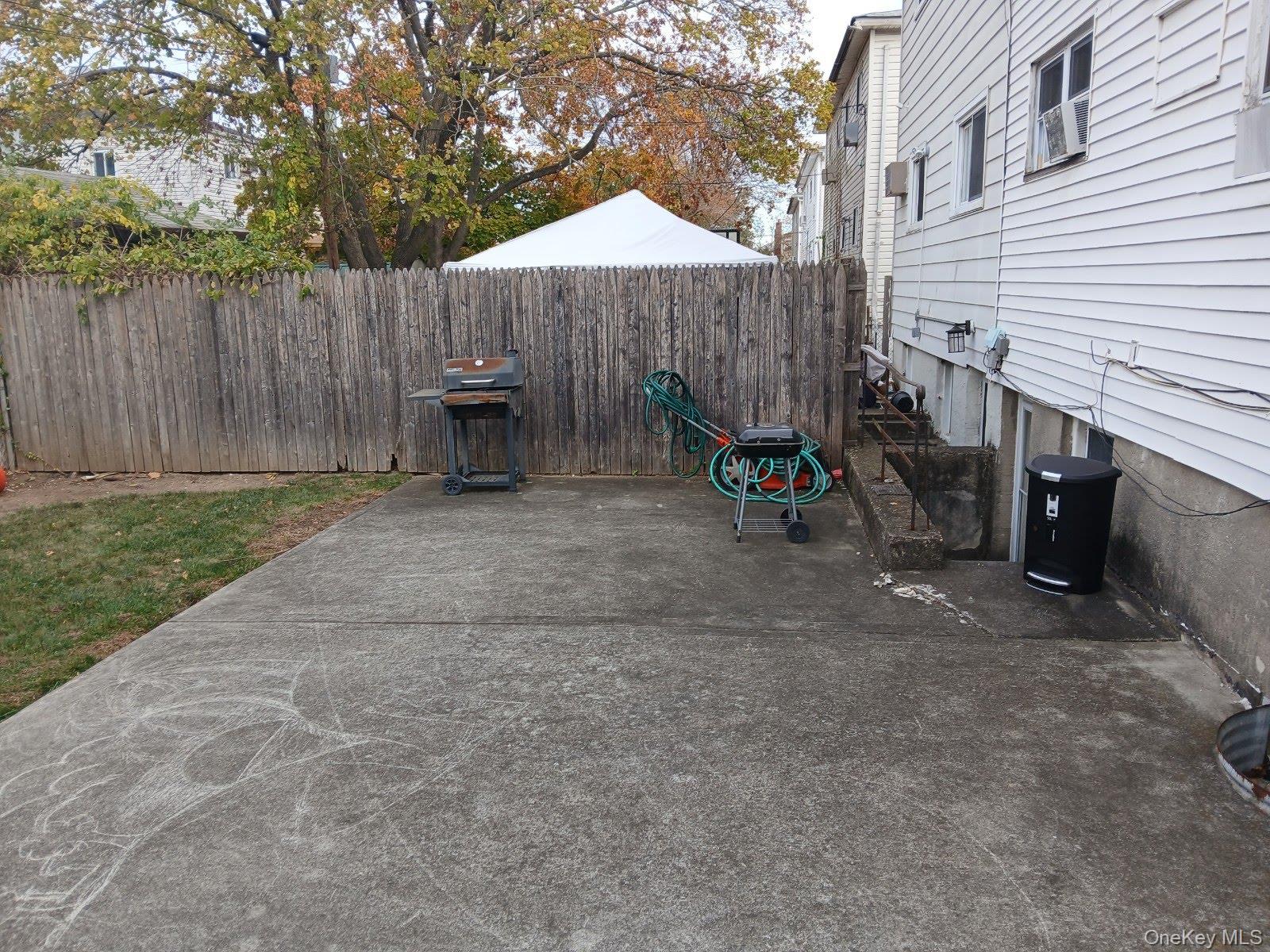 255-29 149th Road Queens, NY 11422 - Photo 22 of 23 a view of a patio with a table and chairs under an umbrella