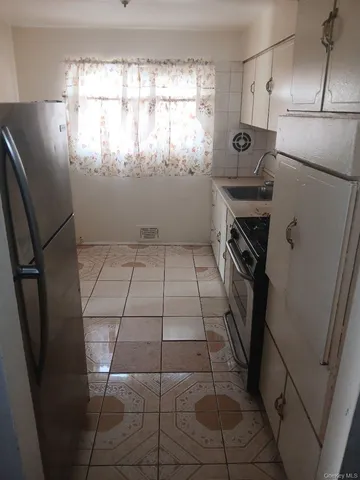 a kitchen with a refrigerator a washer and dryer