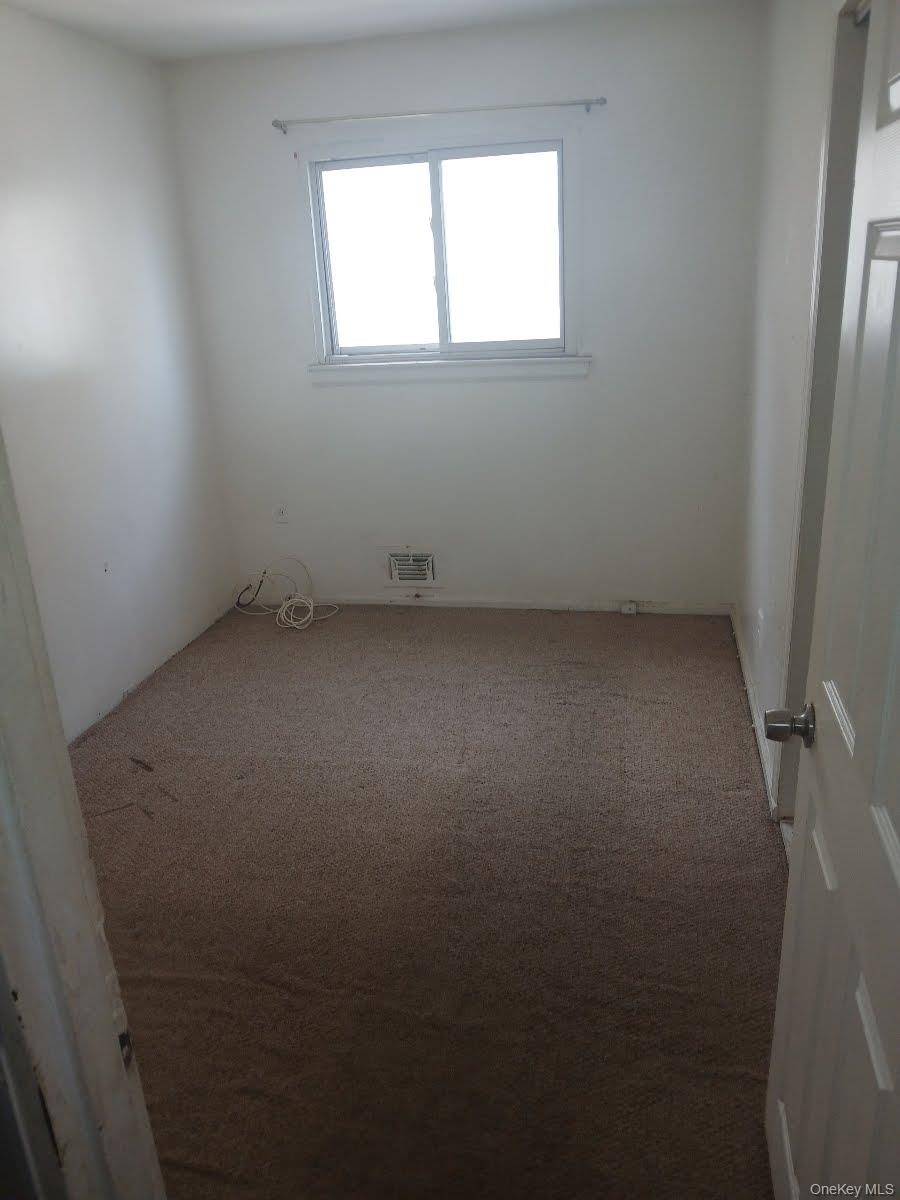 255-29 149th Road Queens, NY 11422 - Photo 8 of 23 an empty room with a window