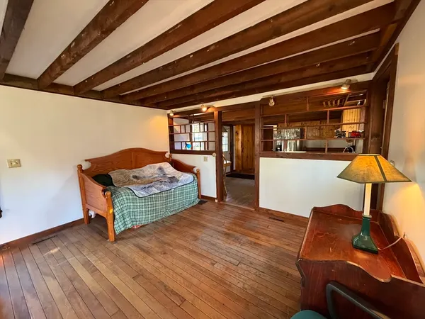 a living room with furniture large window and chandelier