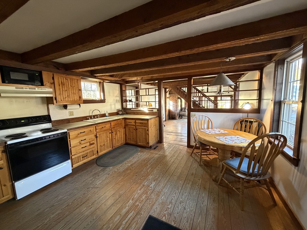 130 Laurel Street Greenfield, MA 01301 - Photo 10 of 31 a kitchen with a wooden table and chairs