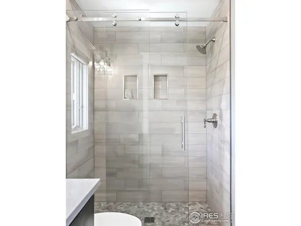 a bathroom with a shower and mirror