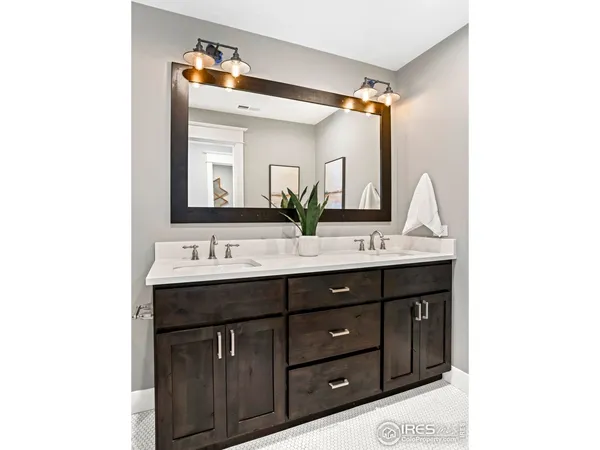 a bathroom with a double vanity sink and mirror
