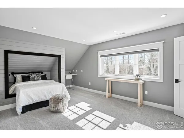 a bedroom with a large bed and a window