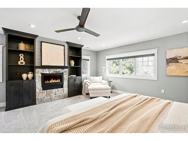 a bedroom with a bed and a fireplace