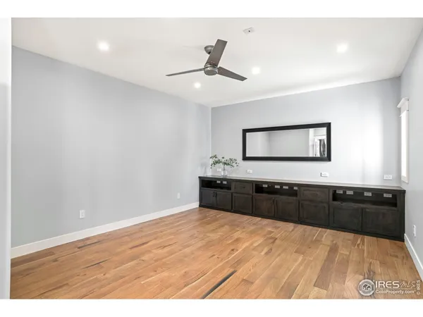 a bedroom with a bed and a mirror