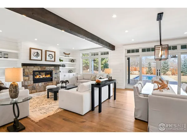 a living room with fireplace furniture and a large window