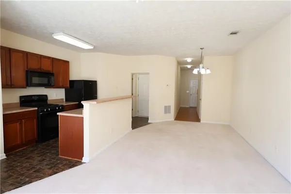 a view of a kitchen with cabinets and stainless steel appliances