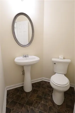 a bathroom with a sink toilet and a mirror