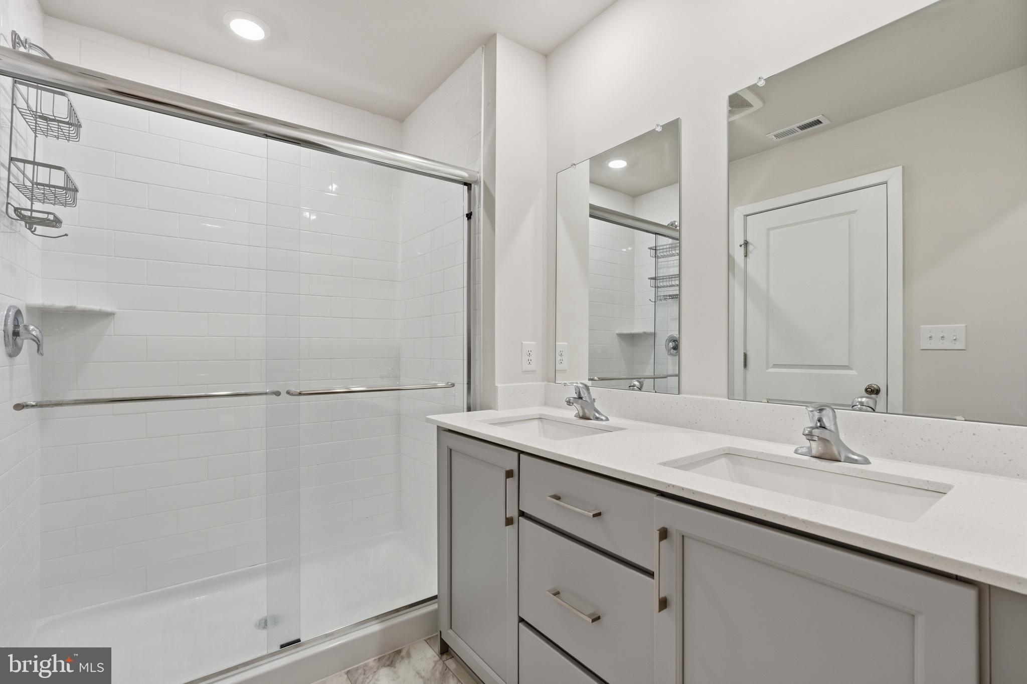 65 East Front Street Bridgeport, PA 19405 - Photo 31 of 49 a bathroom with a double vanity sink and mirror