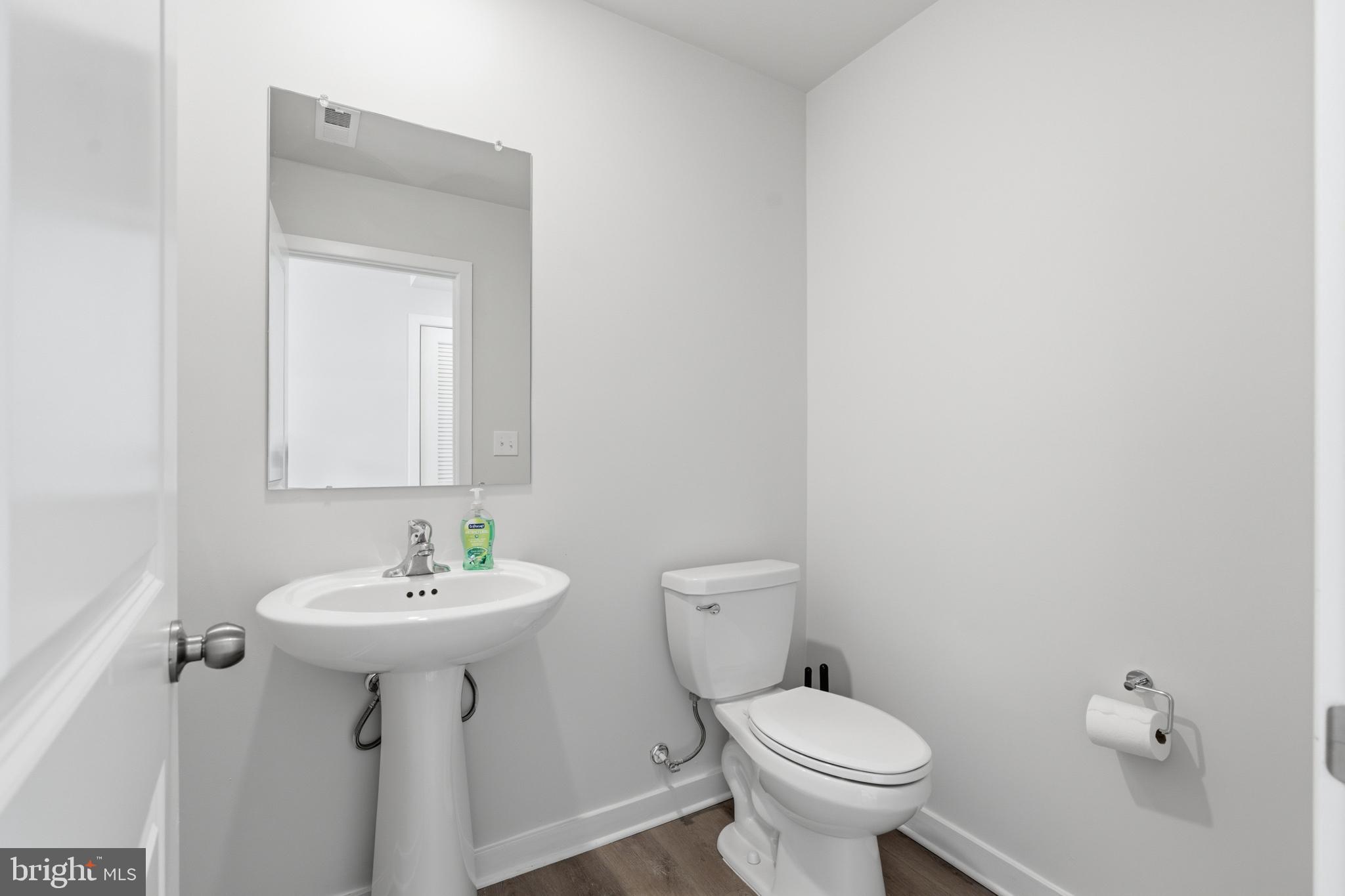 65 East Front Street Bridgeport, PA 19405 - Photo 9 of 49 a bathroom with a sink toilet and a mirror