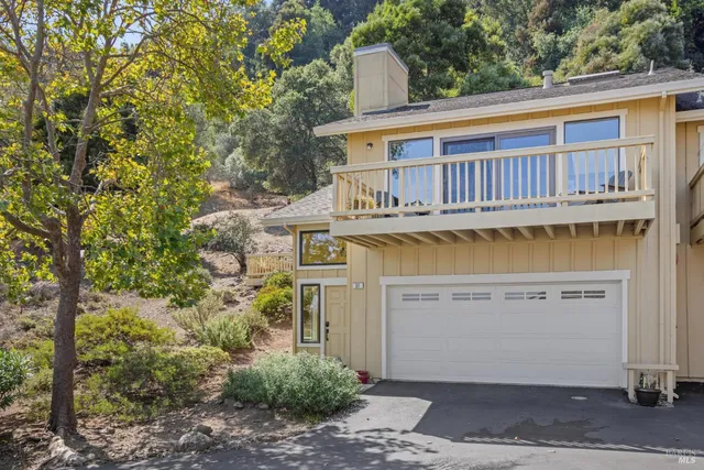 a view of a house with a wooden deck