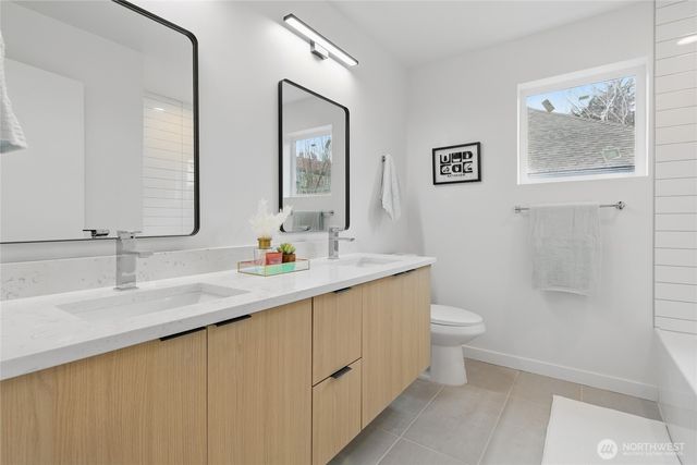 a bathroom with a double vanity sink and a mirror