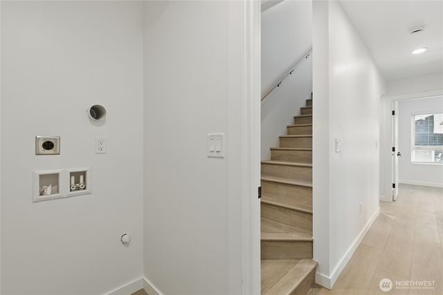 a view of a hallway with wooden floor and entryway