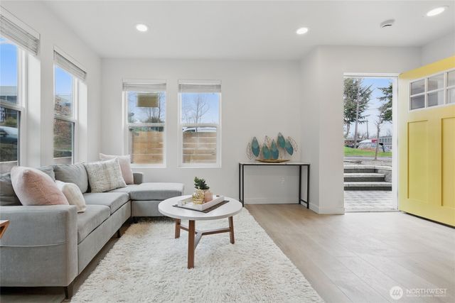 a living room with furniture and a potted plant