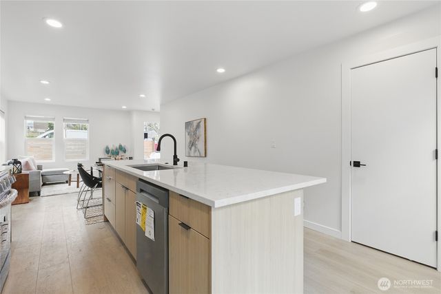 a kitchen with a sink and a refrigerator