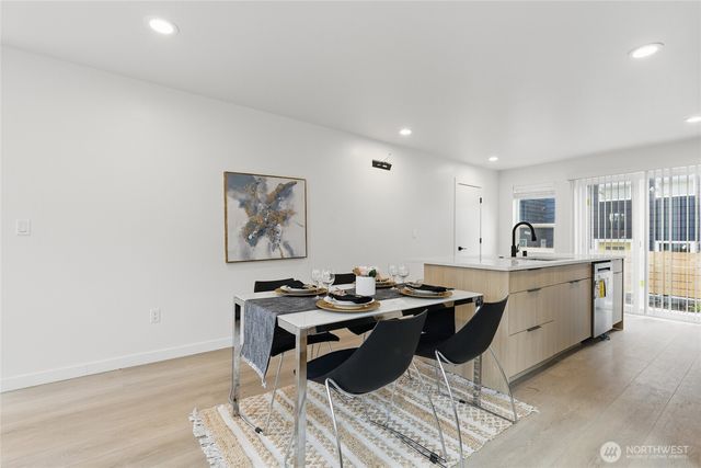 a kitchen with a sink cabinets and wooden floor
