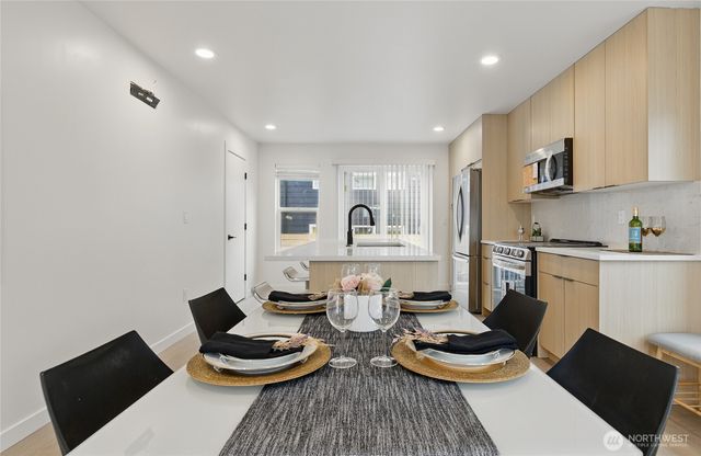a kitchen with a table and chairs in it