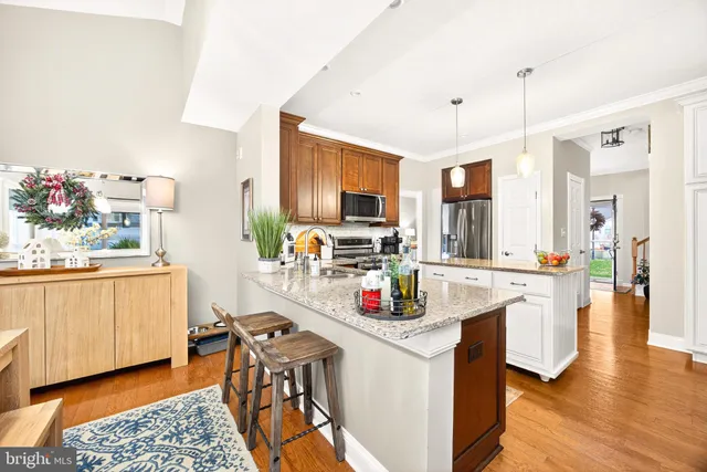 a large kitchen with stainless steel appliances kitchen island granite countertop a large counter top and stainless steel appliances