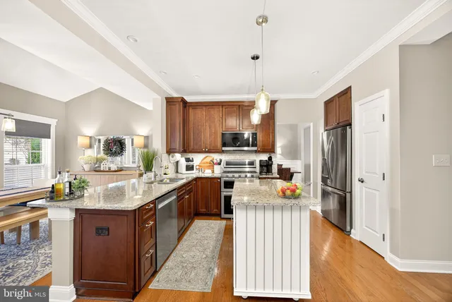 a spacious bedroom with a bed a couch and a ceiling fan