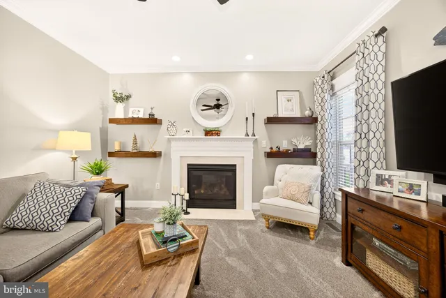 a spacious bedroom with a bed a dresser and a chandelier