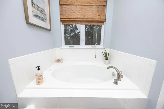 a living room with patio furniture and a large window