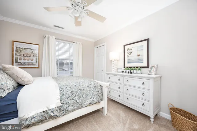 a front view of a house with a garden and yard