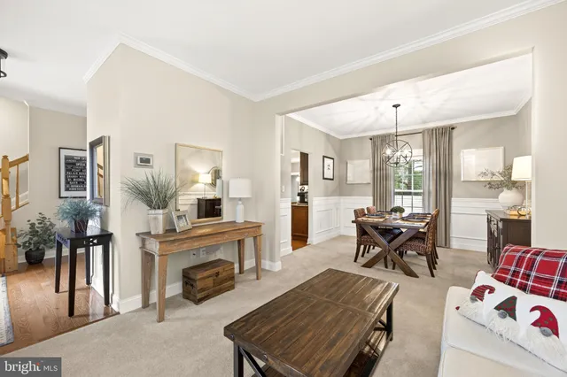 a view of a dining room with furniture large windows and wooden floor