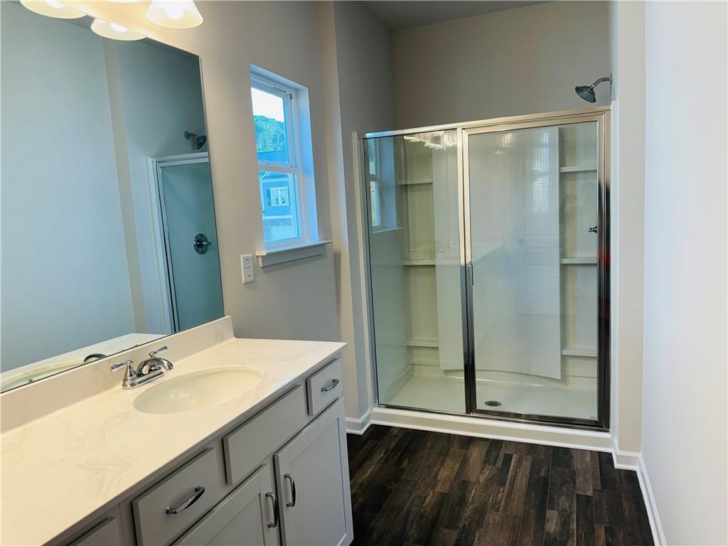 217 Dupont Drive Cartersville, GA 30121 - Photo 4 of 7 a bathroom with a shower sink and mirror