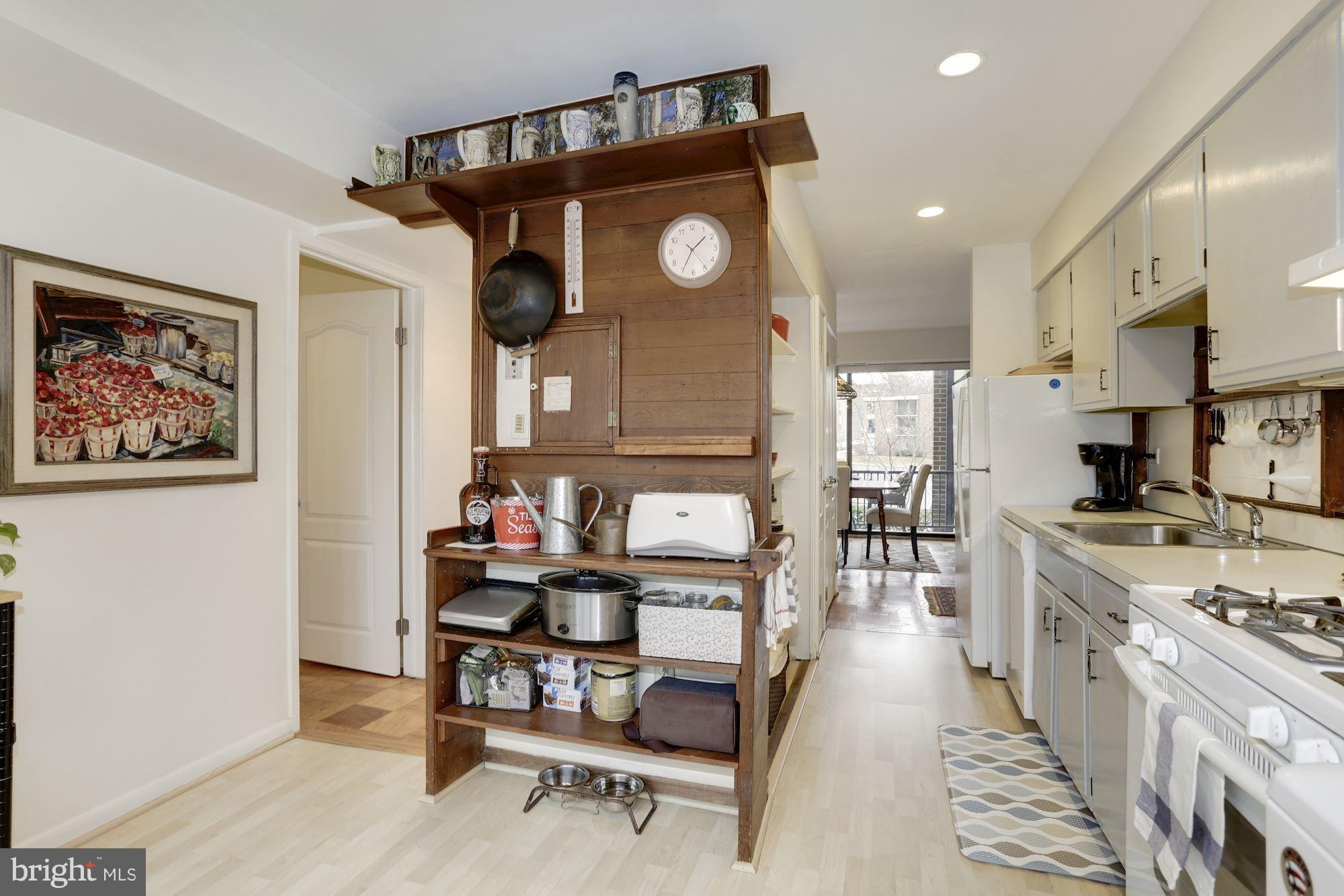 2016 Coleridge Drive, Unit 202 Silver Spring, MD 20902 - Photo 11 of 30 KITCHEN HAS BOTH CLOSET AND OPEN SHELF STORAGE