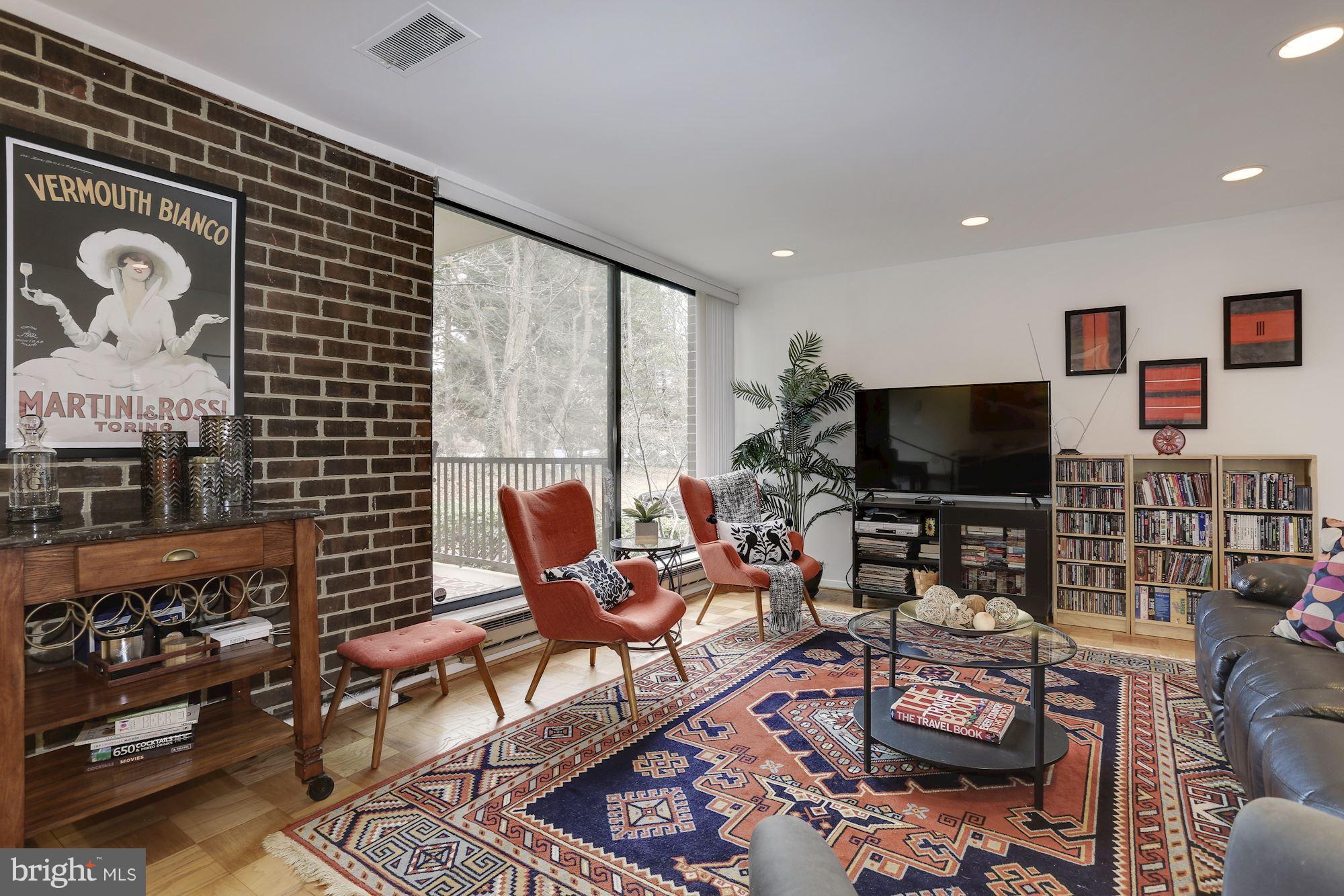 2016 Coleridge Drive, Unit 202 Silver Spring, MD 20902 - Photo 4 of 30 TALL WINDOWS FACING WEST PLUS BRICK ACCENT WALL