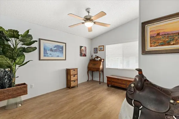 a work room with furniture and a potted plant