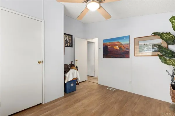 a view of a livingroom with wooden floor and closet