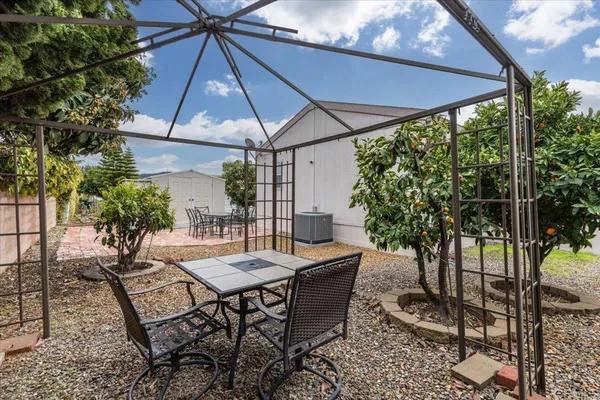 a view of a patio with a table and chairs under an umbrella