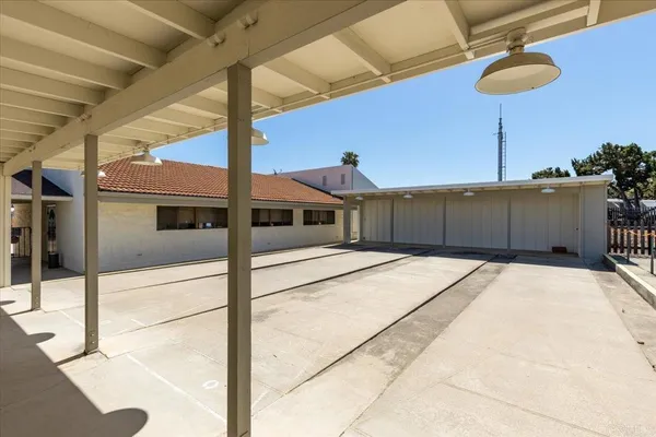 a view of a brick house with a large trees