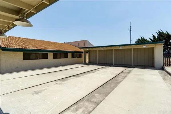a couple of table and chairs under an umbrella