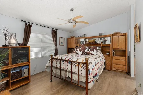 a bed sitting in a bedroom next to a window