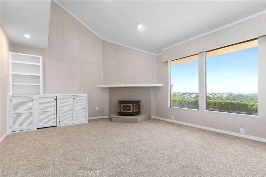 14220 El Monte Road Atascadero, CA 93422 - Photo 23 of 61 an empty room with windows and fireplace