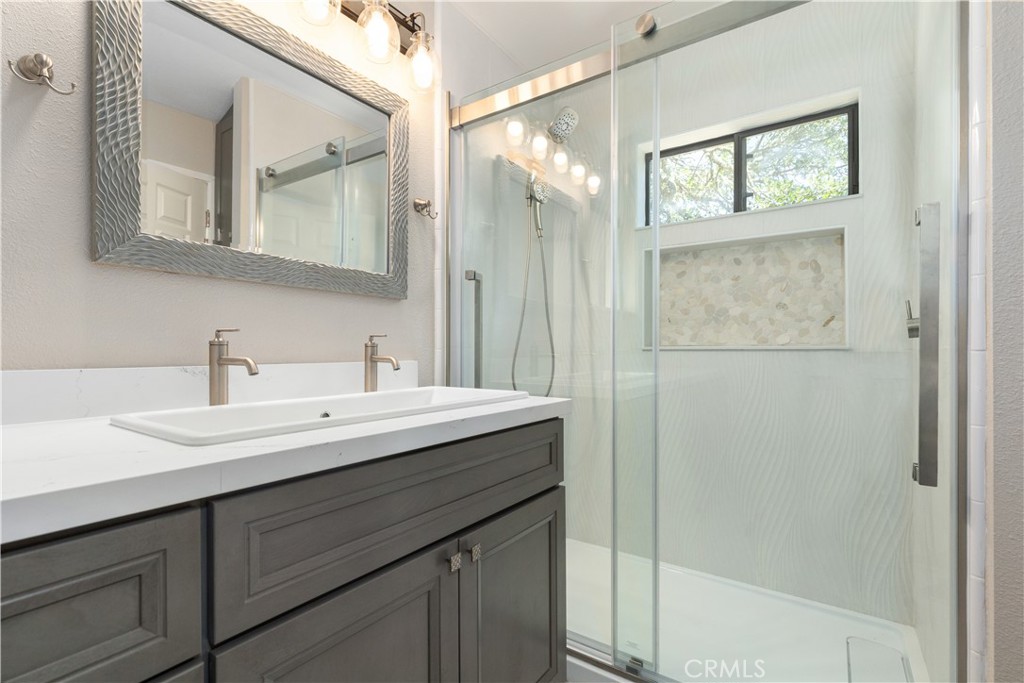 14220 El Monte Road Atascadero, CA 93422 - Photo 42 of 61 a bathroom with a granite countertop sink mirror and double