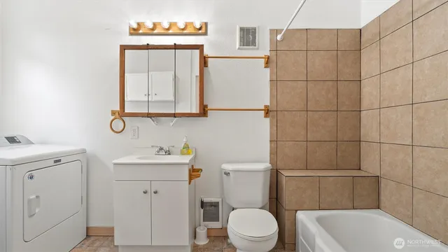 a bathroom with a toilet sink and mirror